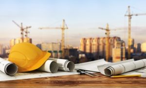 Concept of construction and design. 3d render of blueprints and designer tools on the panorama of construction site.