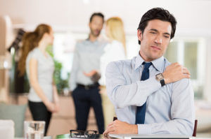 Stressed businessman having neck pain